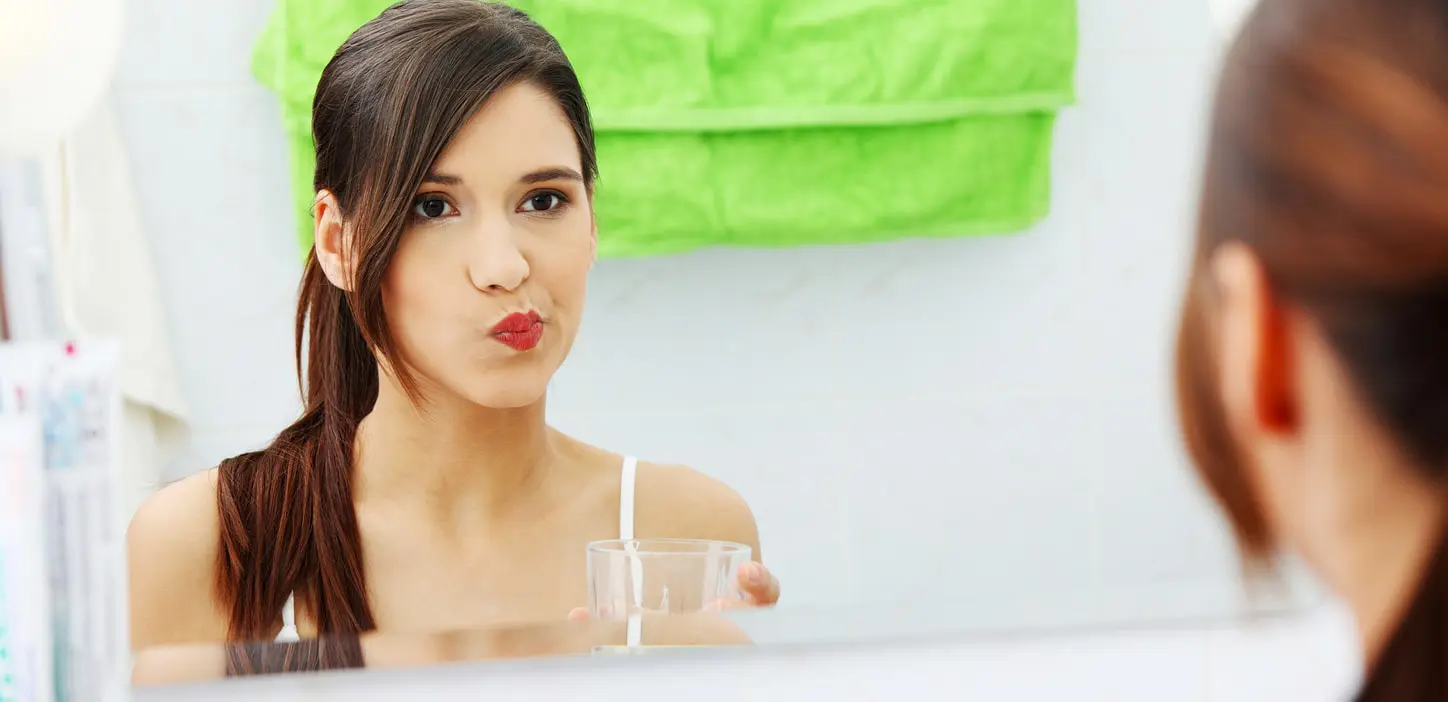 girl using mouthwash