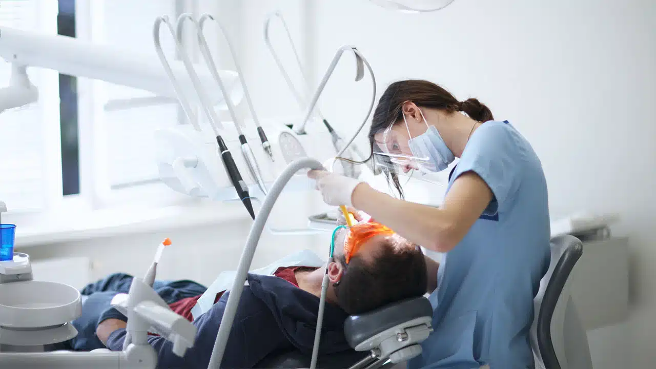 Dentist working on patient in dental chair